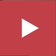 Screenshot of "How to" video. A hand holding a phone in camera mode scanning a QR code